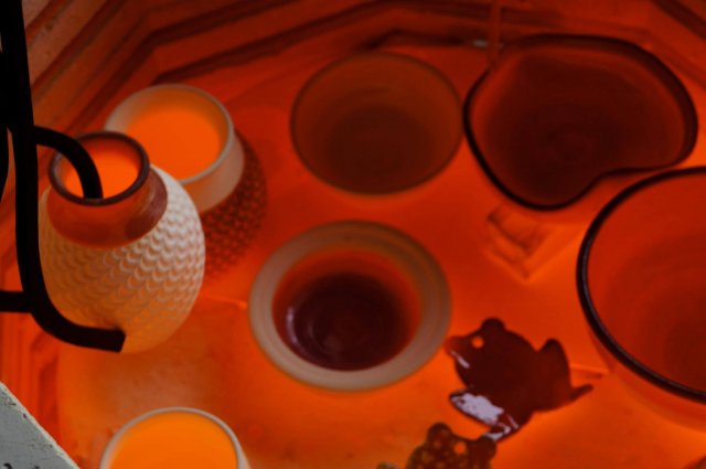 Raku pots are glowing red-hot in the kiln